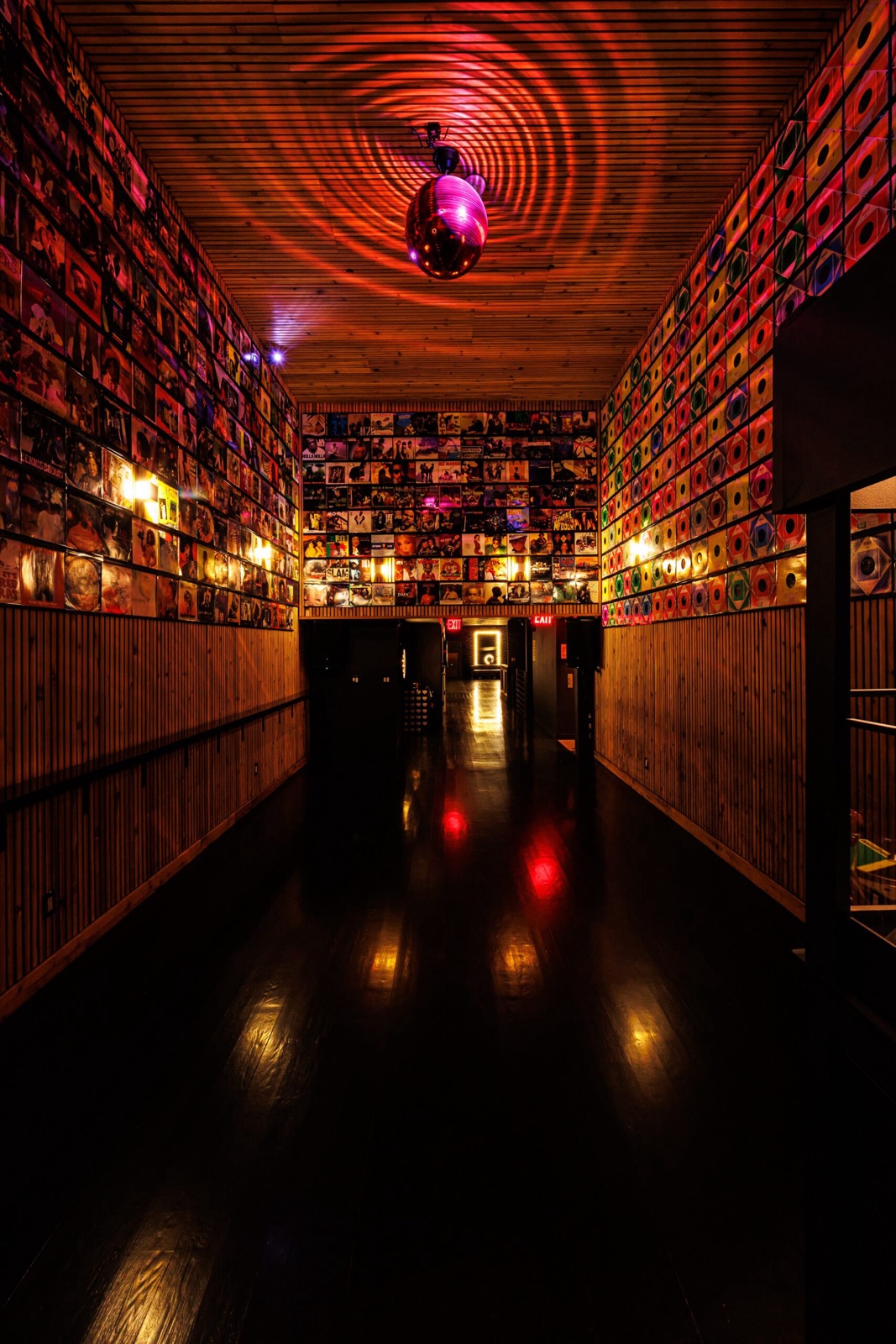 Vinyl record wall and disco ball in the Studio Hundred corridor